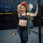 A Woman with Redhead Wearing Sports Bra starting weight loss programs on Mr. Fat Belly.