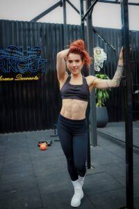 A Woman with Redhead Wearing Sports Bra starting weight loss programs on Mr. Fat Belly.