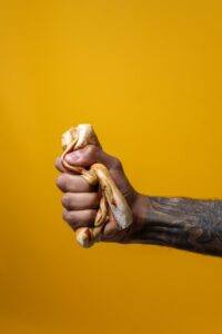 Person Squeezing Hotdog