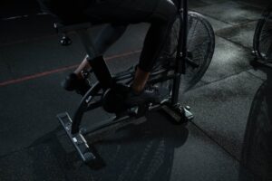 Person in Black Pants Using a Stationary Bicycle