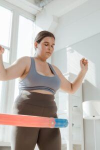 Woman Using Hula Hoop with Her Eyes Closed