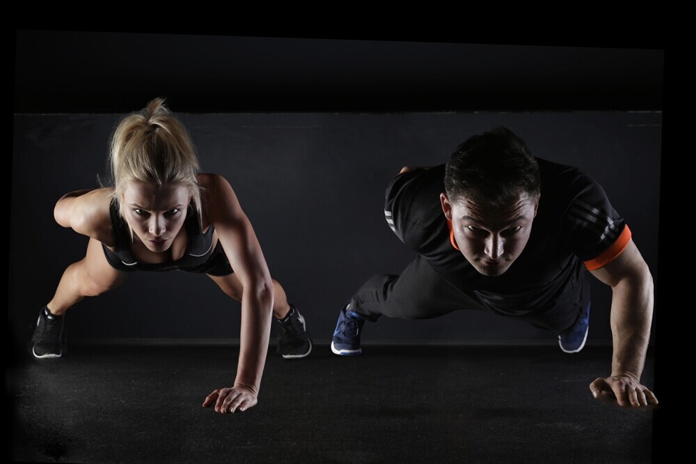 a man and a woman working together in thier weight loss strategies